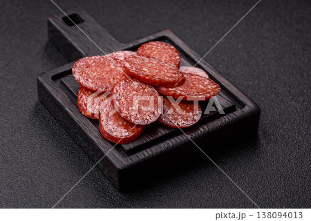 Sliced smoked pepperoni or salami as a pizza topping. Pepperoni sausage Sliced smoked pepperoni or salami as a pizza topping. Pepperoni sausage 138094013