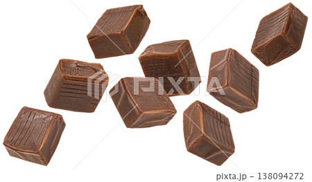 Dark caramel candies isolated, falling chocolate square toffee cubes on white background with clipping path, full depth of field Dark caramel candies isolated, falling chocolate square toffee cubes on white background with clipping path, full depth of field 138094272