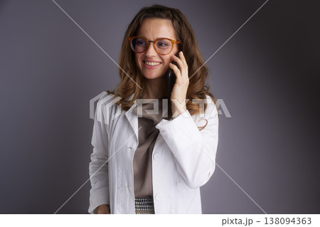 Cheerful Physician Having a Phone Consultation Cheerful Physician Having a Phone Consultation 138094363