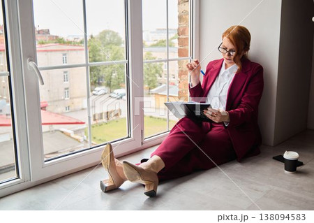 Creative writer takes mindful break observing cityscape thoughtfully 138094583