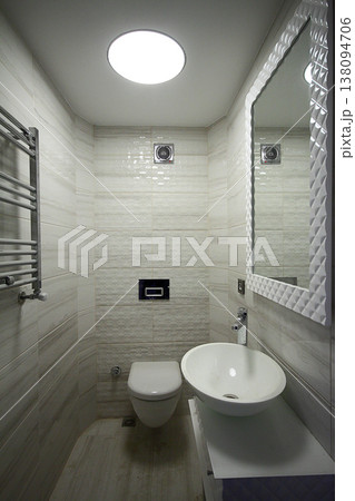 Modern minimalist bathroom with bathtub and clear tiles. Nobody inside Modern minimalist bathroom with bathtub and clear tiles. Nobody inside 138094706