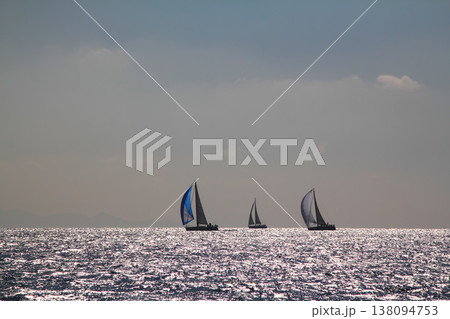 Sailboats sail in windy weather in the blue waters of the Aegean Sea, on the shores of the famous holiday destination Bodrum. 138094753