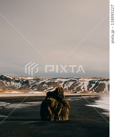 Arnardrangur sea stack on Reynisfjara black sand beach, South Iceland. Arnardrangur sea stack on Reynisfjara black sand beach, South Iceland. 138095227
