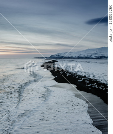 Winter sunrise over Diamond Beach with ice fragments on black sand, South Iceland Winter sunrise over Diamond Beach with ice fragments on black sand, South Iceland 138095260