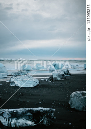 Scattered glacial ice on Diamond Beach under a moody sky, South Iceland. Scattered glacial ice on Diamond Beach under a moody sky, South Iceland. 138095288