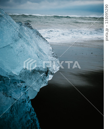 Close-up of a glacial ice fragment on the black sands of Diamond Beach, South Iceland. Close-up of a glacial ice fragment on the black sands of Diamond Beach, South Iceland. 138095290