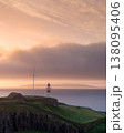Sunset illuminates lighthouse on Torshavn dramatic coastline 138095406