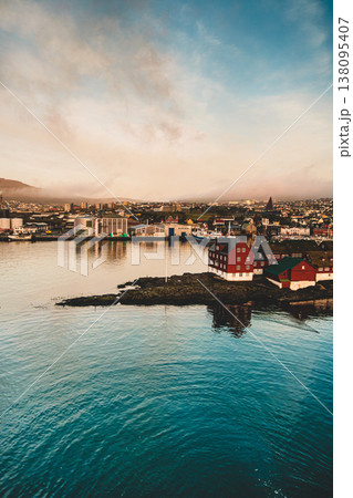 Aerial sunset view of Torshavn, showcasing colorful architecture and serene coastline. 138095407