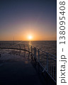 Radiant sunset viewed from a ferry deck, reflecting on wet surfaces 138095408