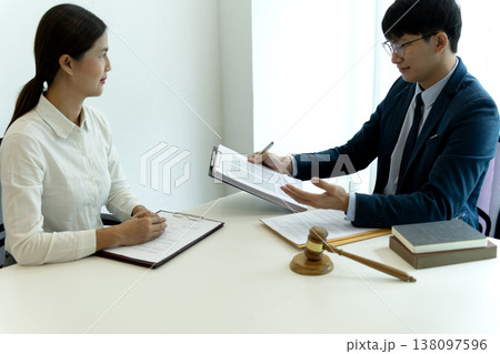 In the law office businessman and businesswoman work for clients to fight lawsuits In the law office businessman and businesswoman work for clients to fight lawsuits 138097596