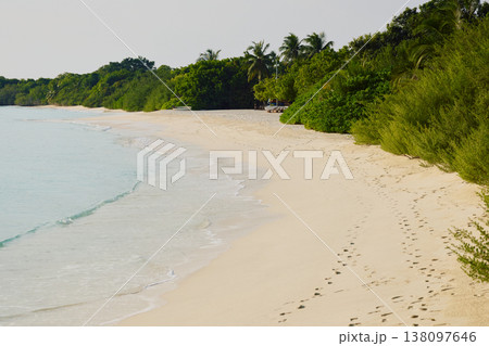 Classic Maldives island landscape on a sunny day, coastal luxury resort buildings, azure water, white sand, palm trees on the shore Classic Maldives island landscape on a sunny day, coastal luxury resort buildings, azure water, white sand, palm trees on the shore 138097646