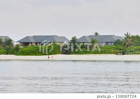 Classic Maldives island landscape on a sunset, azure water, white sand, palm trees on the shore 138097724