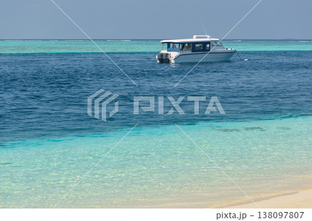 Magical seascape on Maldives islands, tourist boat, reflection on the water in beach, no people Magical seascape on Maldives islands, tourist boat, reflection on the water in beach, no people 138097807