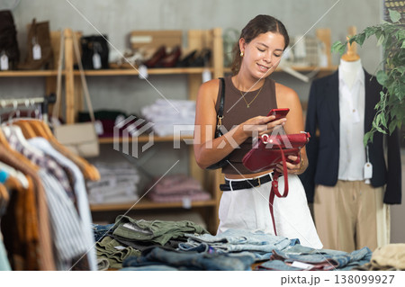 Woman scanning her handbag on her mobile 138099927