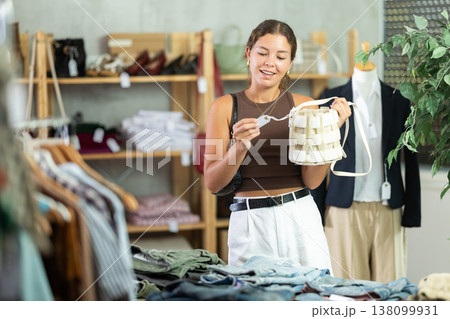 Woman choosing handbags in the store Woman choosing handbags in the store 138099931