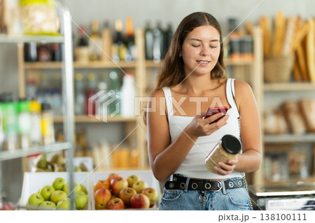 Young woman scanning qr code of beans Young woman scanning qr code of beans 138100111