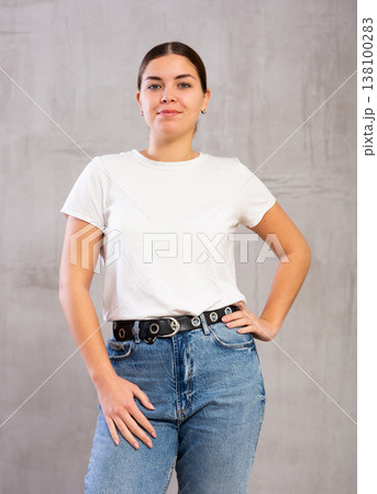 Calm young woman standing in confident pose Calm young woman standing in confident pose 138100283