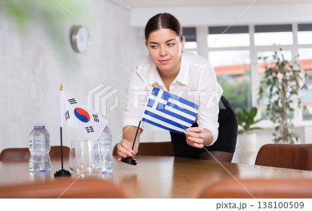 Businesswoman arranging the flags of South Korea and Greece for presentation and negotiations Businesswoman arranging the flags of South Korea and Greece for presentation and negotiations 138100509
