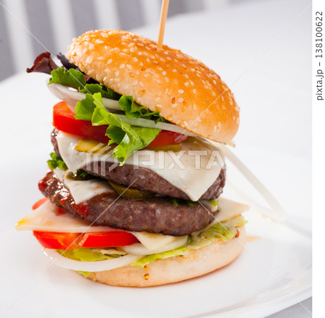 Double cheeseburger with beef, tomato, cheese, cucumber and lettuce 138100622