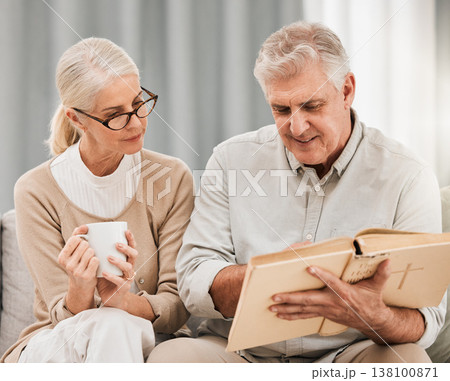 Bible, reading and senior couple in a living room with book for gospel, discussion or learning in their home. God, worship and elderly man with old woman enjoy retirement with holy, praise or faith 138100871