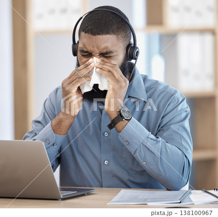 Black man, sick and call center blowing nose with tissue, allergy or flu in customer service at office. African male person, consultant or agent with cold, symptoms or immune virus at workplace 138100967