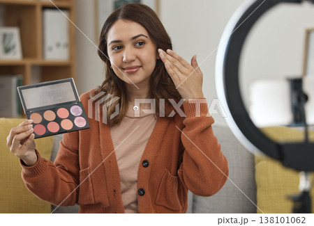 Streaming, makeup and review with a woman influencer in her home to broadcast live content to viewers. Social media, product or tutorial with a young brand ambassador in the living room for cosmetics Streaming, makeup and review with a woman influencer in her home to broadcast live content to viewers. Social media, product or tutorial with a young brand ambassador in the living room for cosmetics 138101062