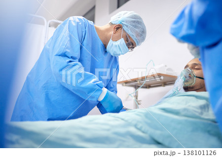 Patient, hospital and surgeon team or emergency service for healthcare or medical procedure. Doctors with a man to start collaboration, oxygen or surgery and operation with support and scrubs in ICU Patient, hospital and surgeon team or emergency service for healthcare or medical procedure. Doctors with a man to start collaboration, oxygen or surgery and operation with support and scrubs in ICU 138101126