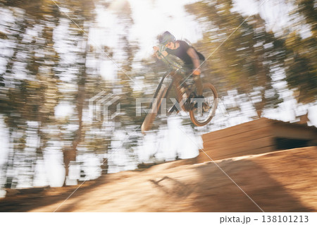 Motion blur, mountain bike and cycling, man with speed for extreme sports and training in fast adventure. Professional dirt race action, off road bicycle competition or performance challenge in woods Motion blur, mountain bike and cycling, man with speed for extreme sports and training in fast adventure. Professional dirt race action, off road bicycle competition or performance challenge in woods 138101213