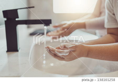 Bathroom, water and child cleaning hands with soap, foam or learning healthy hygiene together. Washing dirt, germs or bacteria on fingers, kid in home in morning for wellness, safety or skin care. 138101258