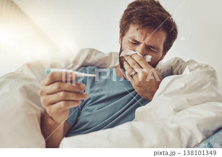 Man, blowing nose and sick with allergies, thermometer to check for fever, virus and bacteria with health fail at home. Toilet paper, healthcare crisis with medical condition and monitor temperature Man, blowing nose and sick with allergies, thermometer to check for fever, virus and bacteria with health fail at home. Toilet paper, healthcare crisis with medical condition and monitor temperature 138101349