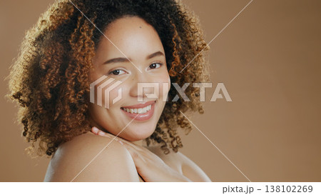 Portrait of happy woman, natural beauty mockup space or cosmetics for wellness in studio with smile. Skin glow, pride or confident biracial female model with skincare results on a brown background 138102269