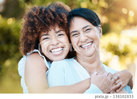 Happy, portrait and woman hugging her senior mother in nature at an outdoor park in summer. Smile, love and young female person from Mexico embracing her elderly mom with care in a field for bonding. 138102833