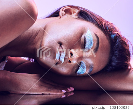 Beauty, glitter makeup and woman in studio with skincare and face with glow isolated on purple background. Eyeshadow, lipstick and bold with sparkle, silver shine and wellness, model with facial art 138103025