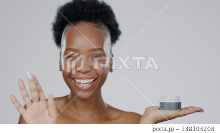 Black woman, portrait and cream with smile, skincare and healthy skin with face, moisturizer and blue studio background. Happy, afro and sunscreen for dermatology, cosmetology and luxury product 138103208