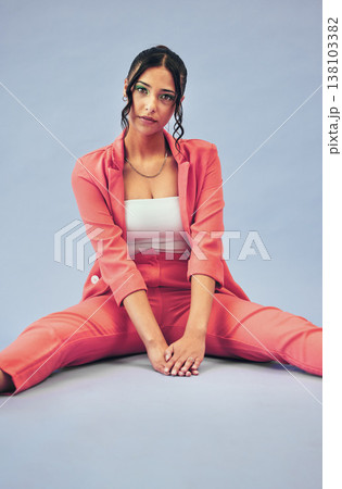 Woman, fashion and portrait of gen z style with cosmetics and sitting in studio. Trendy, stylish suit and relax female person with freedom, cosmetics and modern clothes with blue background Woman, fashion and portrait of gen z style with cosmetics and sitting in studio. Trendy, stylish suit and relax female person with freedom, cosmetics and modern clothes with blue background 138103382
