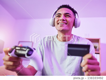 Headphones, credit card and man playing video game ecommerce for purchase with controller in virtual challenge. Internet, user experience and person or esport gamer streaming sports games online Headphones, credit card and man playing video game ecommerce for purchase with controller in virtual challenge. Internet, user experience and person or esport gamer streaming sports games online 138103492