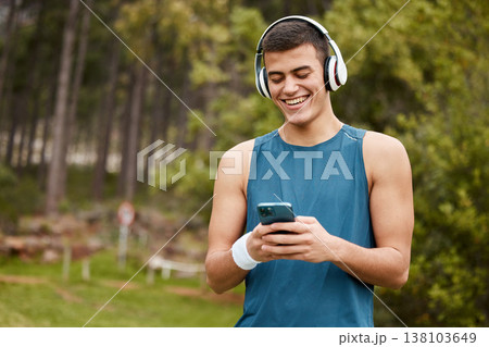 Fitness, headphones and a man outdoor with a phone listening to music with banner. Happy runner, athlete or sports person in nature park to start exercise, workout or training while streaming radio Fitness, headphones and a man outdoor with a phone listening to music with banner. Happy runner, athlete or sports person in nature park to start exercise, workout or training while streaming radio 138103649