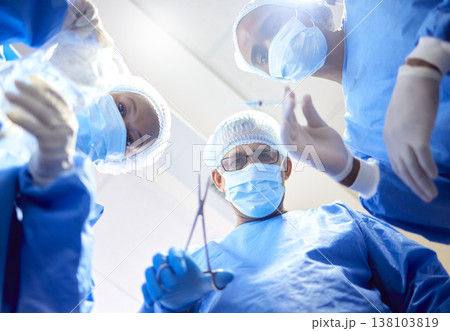 Hospital, tools and surgeon team in theatre for emergency, healthcare or medical procedure. POV, below and doctors for collaboration, portrait or surgery and operation with support and scrubs in ICU Hospital, tools and surgeon team in theatre for emergency, healthcare or medical procedure. POV, below and doctors for collaboration, portrait or surgery and operation with support and scrubs in ICU 138103819
