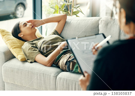 Headache, soldier or woman in therapy for trauma counselling from military war for mental health support. PTSD stress, sofa or depressed person talking to army therapist to help with psychology 138103837
