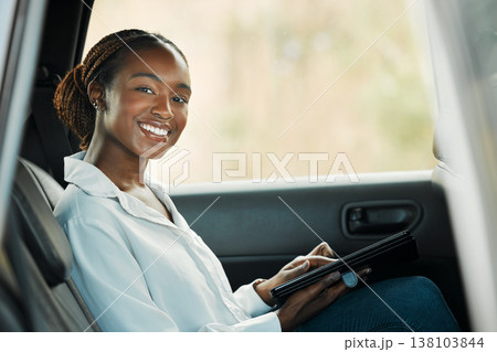 Portrait, tablet and a business black woman a taxi for transport or ride share on her commute to work. Smile, technology and a happy young employee in the backseat of a cab for travel as a passenger 138103844