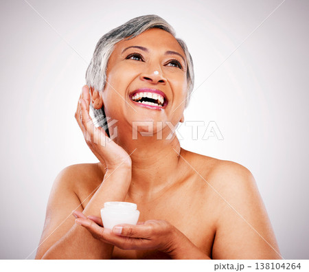 Face cream, skin and beauty of a mature woman with natural glow on a white background. Dermatology, moisturizer and cosmetics of aesthetic model for facial shine, wellness or self care in studio Face cream, skin and beauty of a mature woman with natural glow on a white background. Dermatology, moisturizer and cosmetics of aesthetic model for facial shine, wellness or self care in studio 138104264