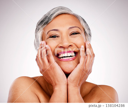 Happy senior woman, portrait and skincare in makeup or cosmetics against a studio background. Face of mature female person smile in happiness for healthy, perfect or soft skin from facial treatment Happy senior woman, portrait and skincare in makeup or cosmetics against a studio background. Face of mature female person smile in happiness for healthy, perfect or soft skin from facial treatment 138104286