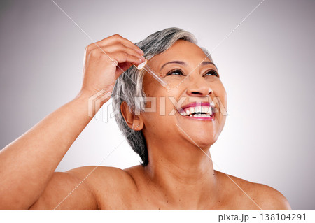 Studio face, mature happy woman or serum hydration, self care and application of facial oil, hyaluronic acid or wellness. Pipette, skincare shine and person thinking of anti aging on white background Studio face, mature happy woman or serum hydration, self care and application of facial oil, hyaluronic acid or wellness. Pipette, skincare shine and person thinking of anti aging on white background 138104291