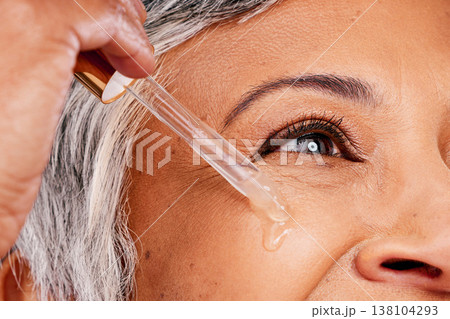 Beauty face, mature woman or serum skincare hydration, anti aging collagen or studio essential oil. Retinol dropper, closeup skin texture or eye of model with facial cosmetic care on white background Beauty face, mature woman or serum skincare hydration, anti aging collagen or studio essential oil. Retinol dropper, closeup skin texture or eye of model with facial cosmetic care on white background 138104293