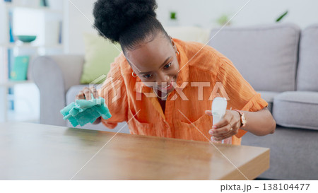 Woman, spray and cloth for cleaning the counter, disinfection and detergent for bacteria on wooden table. Black person, sanitize and chemical or wipe, dust and dirt or germs, smile and routine Woman, spray and cloth for cleaning the counter, disinfection and detergent for bacteria on wooden table. Black person, sanitize and chemical or wipe, dust and dirt or germs, smile and routine 138104477