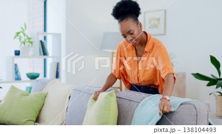 Woman, cleaning and housework in living room, pillow and tidy and organized or neat on furniture. Black person, domestic and chores for hygiene and sanitary cleanup for fresh home and apartment 138104493