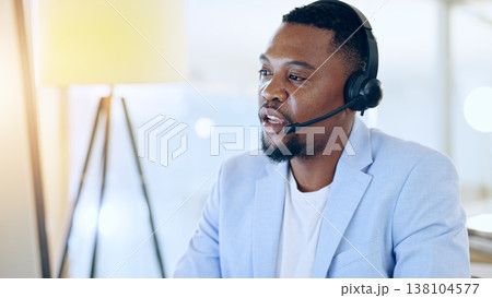 Call center, crm and black man talking for telemarketing, tech support or contact us at help desk in office. Customer service, sales agent and serious consultant in communication, advice and business 138104577