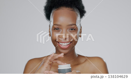 Face, model and hands in beauty cream for cosmetic, glow and happiness with skincare in studio background. Black woman, healthy skin and dermatology for cosmetics in moisturizer, smile and mockup 138104629