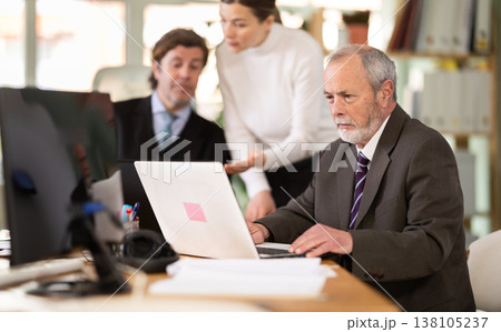 Mature man working in a team in an office Mature man working in a team in an office 138105237