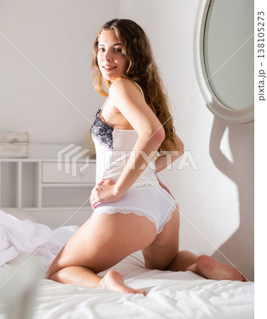 Rear view of cute young girl with long hair in lingerie Rear view of cute young girl with long hair in lingerie 138105273